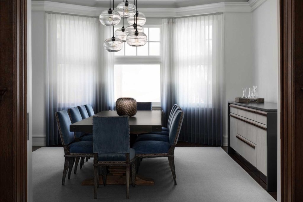 Dining room with blue upholstered chairs and custom sideboard