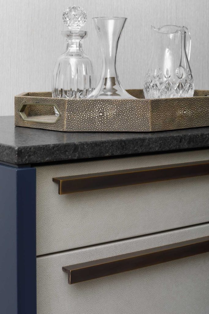 Detail of custom sideboard with glassware on a tray