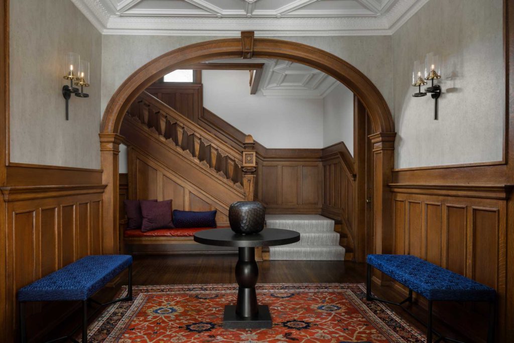 Entry hall with stairs, seating and dramatic ceiling