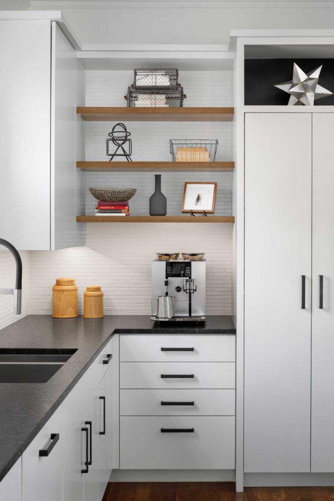 White kitchen cabinets with black accent handles