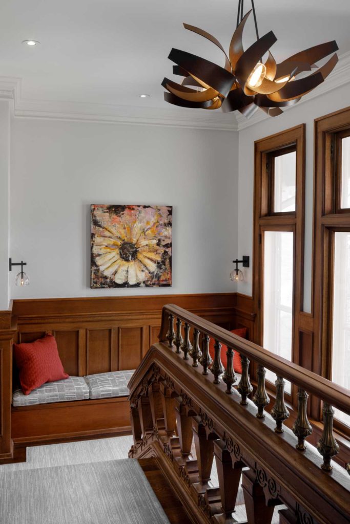 Window seat on stairway landing and modern light fixture