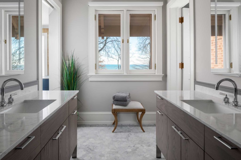 Matching marble top vanities on opposite walls