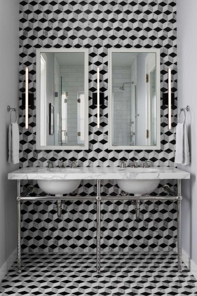 Double vanity with metal accents and geometric floor and wall tiles