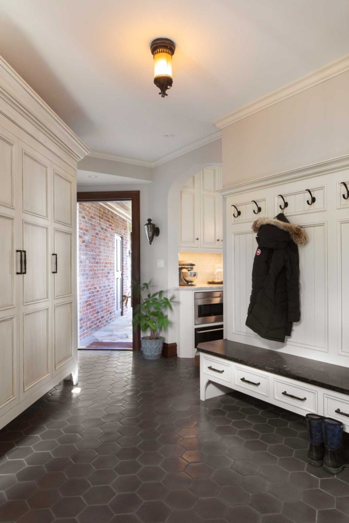 Mudroom entrance with storage and coat hooks