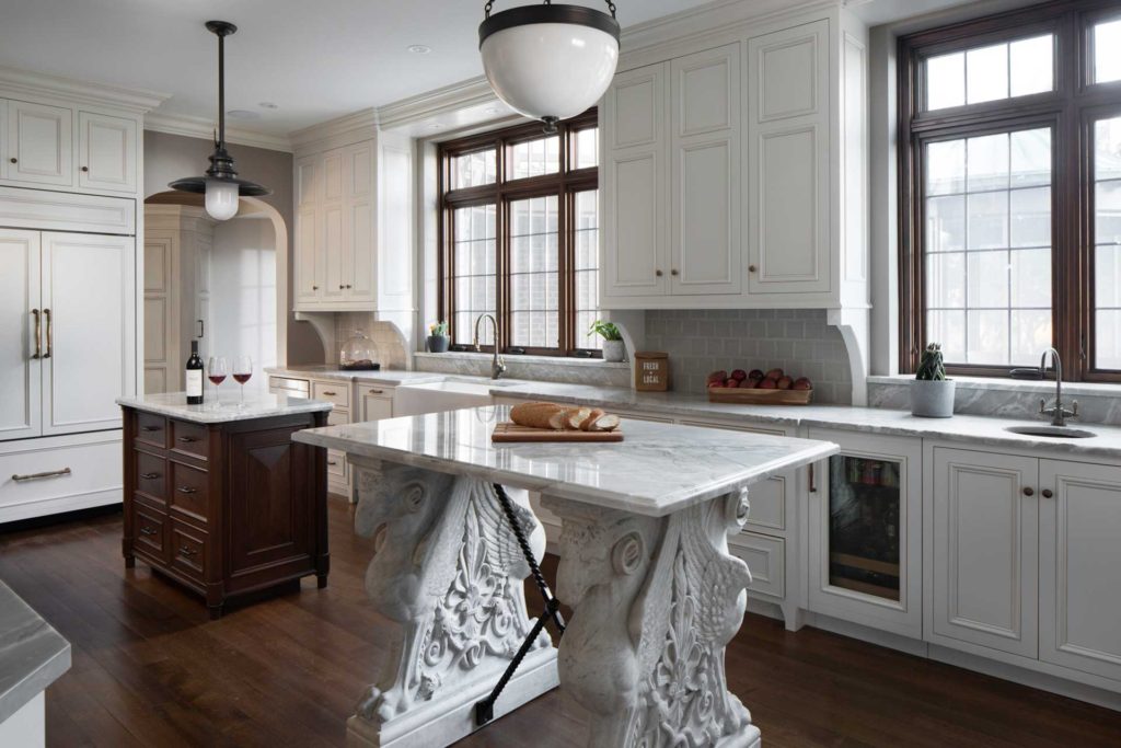 Kitchen with two islands, one supported by winged rams