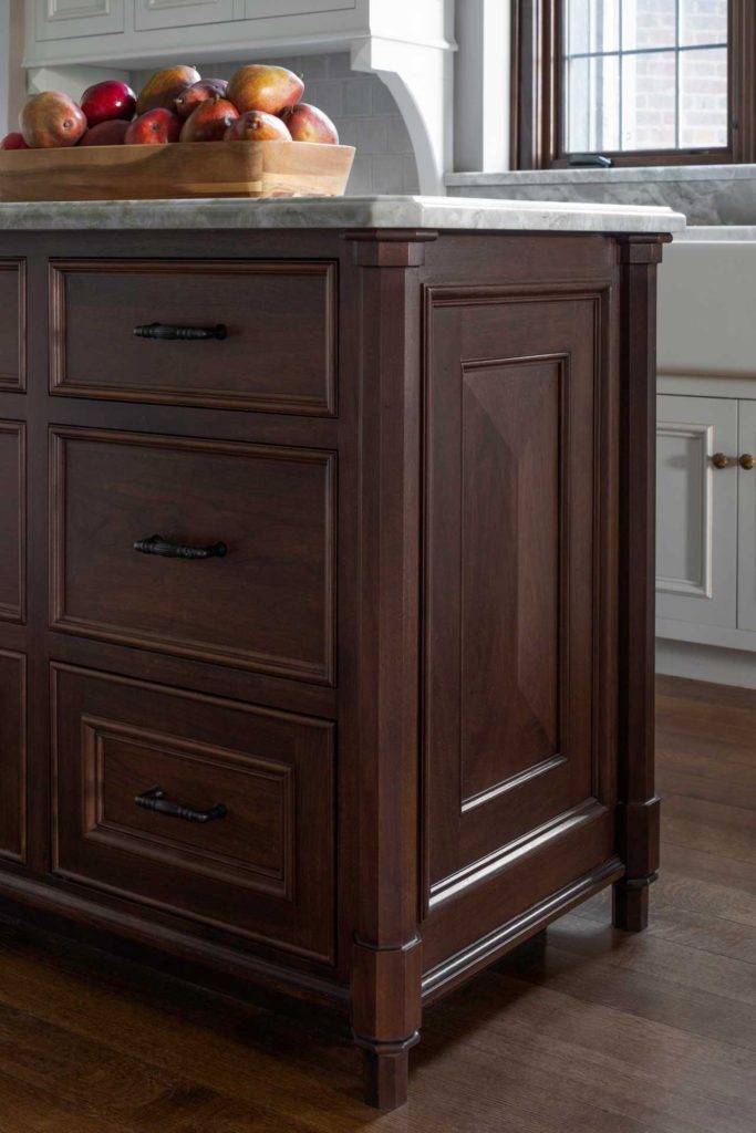 Close-up of kitchen island with dark wood and marble top