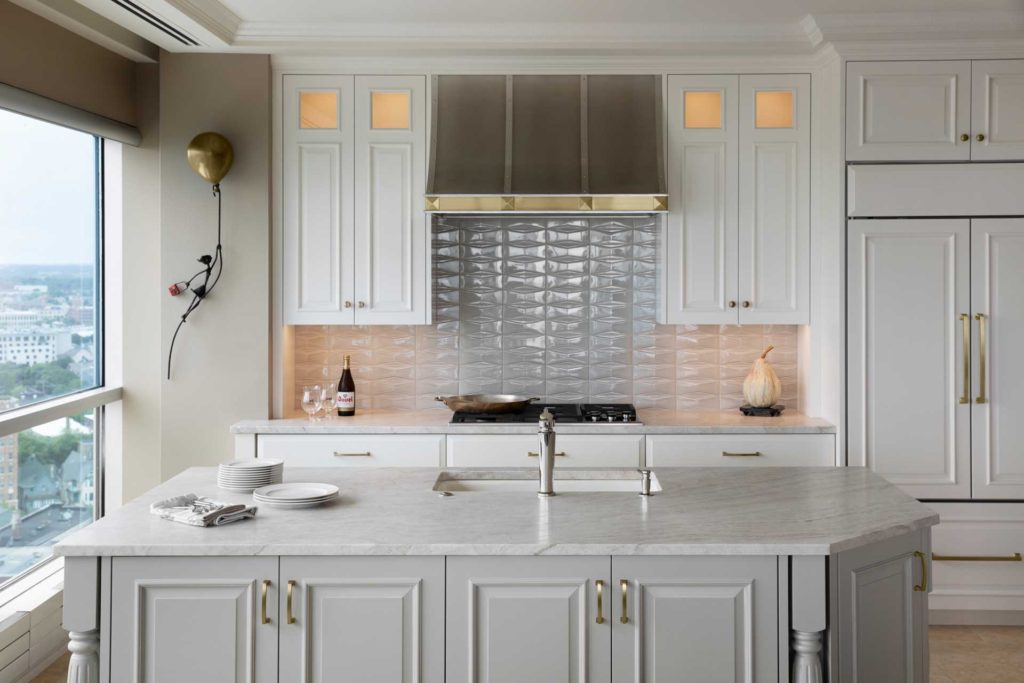 Kitchen view of island sink and cook top