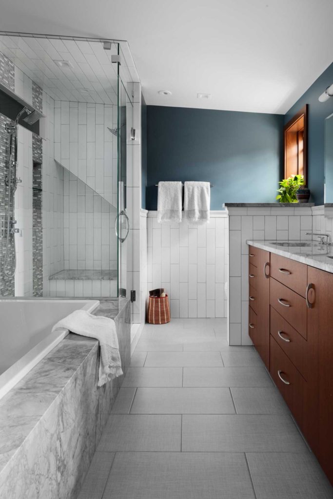 Master bath with tub and glass shower surround